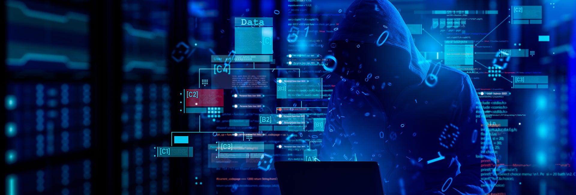 A dark hooded figure typing on a laptop, surrounded by glowing blue code and data elements, representing hacking activity.